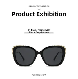 Front detail of black sunglasses with golden woven metal texture on frame and grey lenses