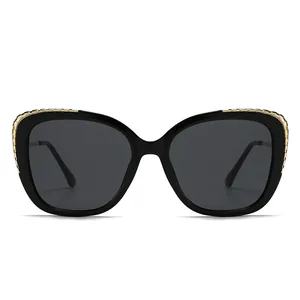 Classic black cat-eye sunglasses with gold metal chain detailing and UV protection lenses