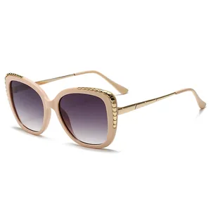 Chic beige cat-eye sunglasses with gold chain trim and gradient lenses at 45-degree angle