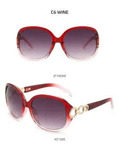 Vue détaillée des lunettes de soleil bordeaux avec branches dorées et verres dégradés