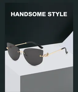 Detail of gold metal temples and chain decoration on rimless polygon sunglasses