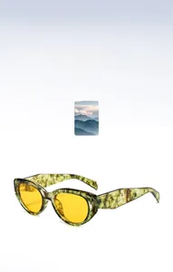 Close-up of green marble frame sunglasses with vibrant yellow transparent lenses