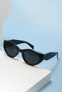 Detail view of bold black cat-eye sunglasses with thick frames and dark lenses