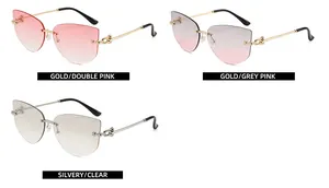 Close-up of cat-eye rimless sunglasses with gold and silver metal temples and gradient lenses