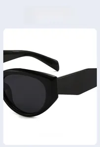 Side view of black cat-eye sunglasses featuring thick frames and smooth geometric temples