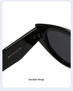 Close-up of sturdy metal hinge and size specifications on black cat-eye sunglasses