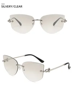 Detail of rimless cat-eye sunglasses with silver metal frame and clear gradient lenses