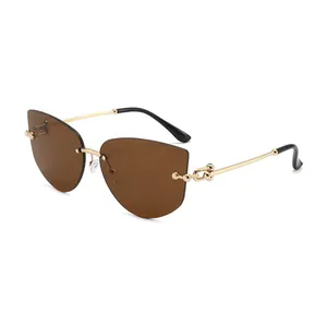 Frameless polygonal sunglasses with brown cat-eye lenses and golden metal chain temples