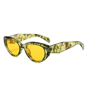 Polygonal cat-eye sunglasses with green marble frame and yellow lenses, front view