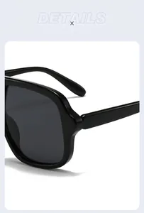 Macro view of the streamlined hinge and glossy black frame on stylish aviator sunglasses