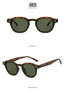 Detail view of retro round sunglasses with tortoiseshell frames and green lenses