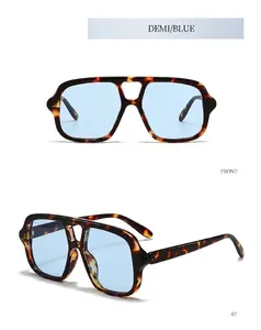 Detail view of retro aviator sunglasses with tortoise frames and blue tinted lenses