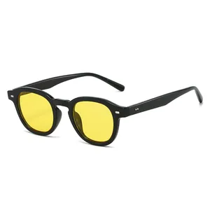 Modern round retro sunglasses with black frames, yellow lenses and silver rivets