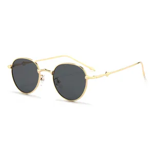 Vintage round metal sunglasses with gold frames and dark lenses in a 45-degree view