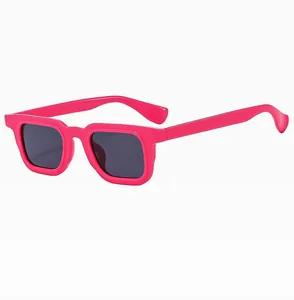 Detail of pink square sunglasses featuring dark lenses and a premium glossy frame