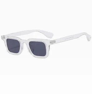 Close-up of retro square sunglasses featuring transparent frame and dark grey lenses