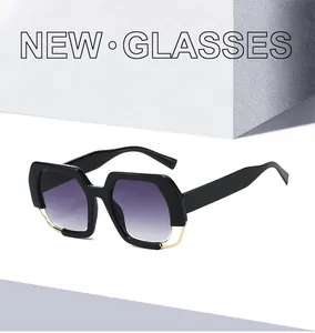 Detail of geometric black sunglasses with purple gradient lenses and gold hollow metal frame