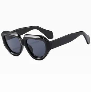 Detail shot of the thick geometric frame and glossy black finish on trendy sunglasses
