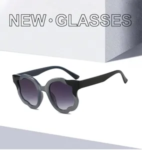 Close-up of wavy frame sunglasses with purple gradient lenses and geometric shadows