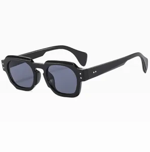 Detailed side view of black polygonal sunglasses featuring silver rivet accents on frame