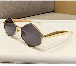 Detail of trendy polygonal gold metal sunglasses with dark polarized lenses on display