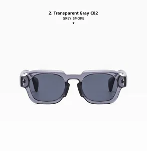 Detail of transparent grey square frame sunglasses with metal rivet accents and smoke lenses
