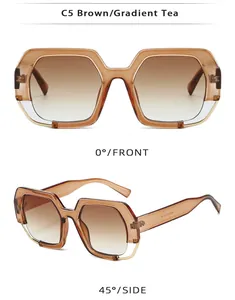 Detail of square oversized brown resin sunglasses with golden metal trim and gradient tea lenses