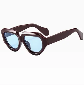 Detail of square frame sunglasses with thick burgundy frames and light blue lenses