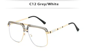 Detail shot of golden metal frame with modular black and white temple tips on glasses