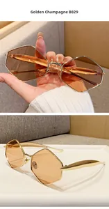 Detailed macro of polygonal golden metal sunglasses with champagne tinted lenses