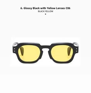 Detail of retro polygon glossy black frame sunglasses with bright yellow lenses and dual rivets