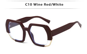 Detail view of wine red geometric square glasses with elegant gold metal trim accents