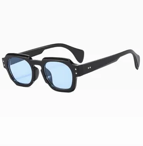 Detail of square black acetate sunglasses frame with retro light blue tinted lenses