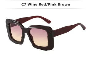 Detail of wine red geometric square sunglasses with pink brown gradient lenses