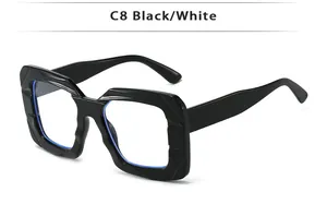 Detail view of bold square black frame sunglasses with trendy geometric cut accents