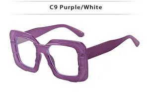 Detail of square purple eyeglass frame with geometric texture and white inner layer