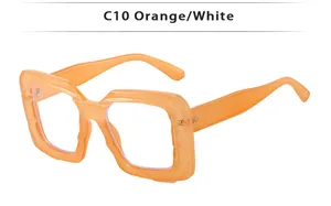 Detail of square orange sunglasses with unique irregular wavy textured carving on the frame