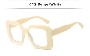 Detail of square beige sunglasses frame featuring geometric engraved lines and C12 style