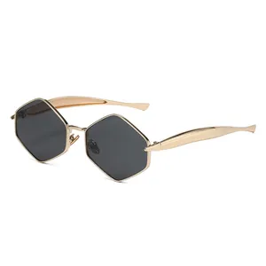 Chic hexagonal gold metal sunglasses with dark gray lenses in a stylish profile view