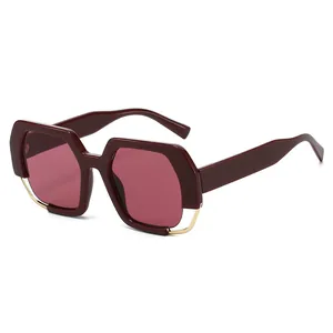 Modern oversized deep wine red sunglasses with gold metal accents and 45-degree angle view