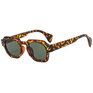 Retro polygonal tortoise shell sunglasses with dark green lenses and metal rivets on white background