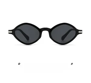 Detailed view of silver striped metal hinge on black oval cat-eye sunglasses