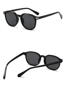 Detail view of oval sunglasses showing the frame dimensions 54-18-143 and metal hinges