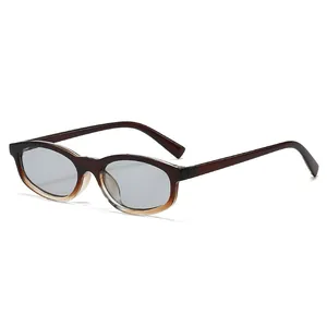 Retro oval sunglasses with gradient amber frames and light gray lenses in a side view