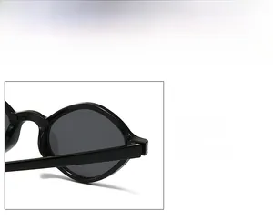 Detail shot of black oval sunglasses frames with high-quality hinges and polished texture