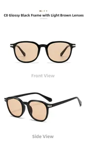 Detail of glossy black oval sunglasses with light tea lenses and silver metal hinges