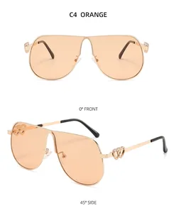 Vues de face et de profil de lunettes de soleil dorées surdimensionnées aux verres orange
