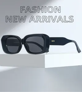 Detailed close-up of side temple with golden double rivets on black rectangle sunglasses