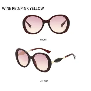 Detailansicht der weinroten ovalen Sonnenbrille mit rosa-gelben Verlaufsgläsern und Goldakzent