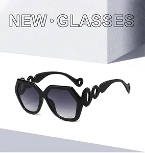 Detail of stylish hexagonal sunglasses with unique curved interlaced temple design